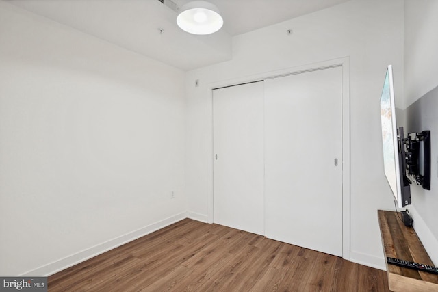 2030 8th St NW Unit Ph-5, Washington, DC 20001 - unfurnished bedroom featuring wood finished floors, a closet, and baseboards