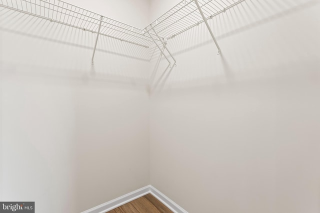 spacious closet with wood finished floors