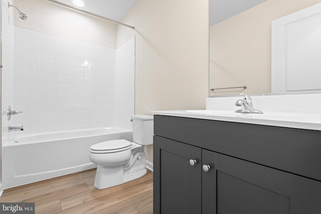 full bathroom with toilet, washtub / shower combination, wood finished floors, and vanity