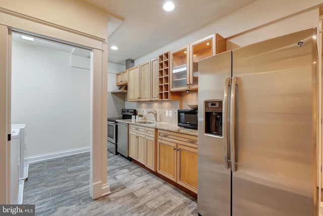 7312 Gordons Rd, Falls Church, VA 22043 - kitchen featuring appliances with stainless steel finishes, a sink, decorative backsplash, light wood-style flooring, and glass insert cabinets