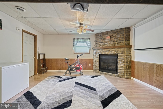 workout room featuring visible vents, wood finished floors, a drop ceiling, and a wainscoted wall