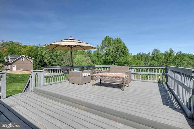 wooden deck featuring a yard and outdoor lounge area