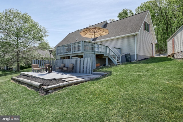 back of property featuring stairway, a patio, a wooden deck, and a lawn