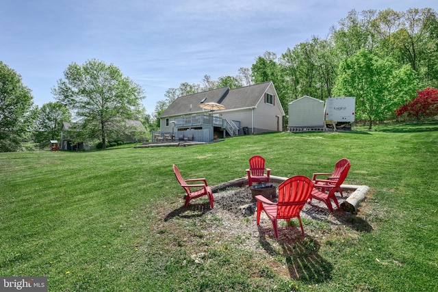 view of yard featuring an outdoor fire pit and a wooden deck