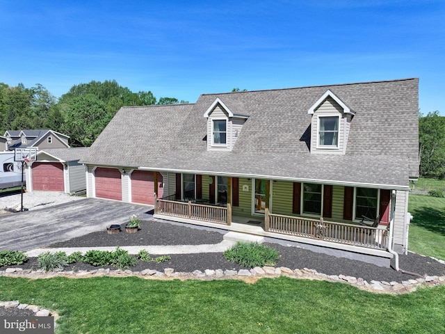 cape cod home with a garage, covered porch, and a front yard