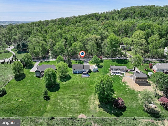 birds eye view of property with a forest view