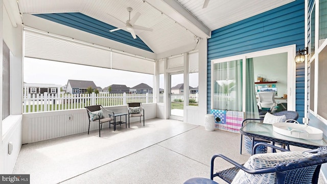 sunroom / solarium with a ceiling fan