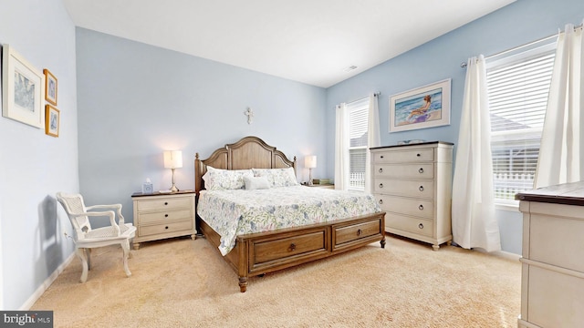bedroom with light carpet and baseboards