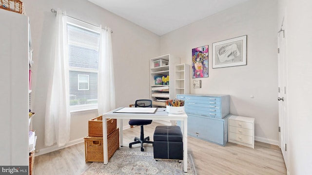 office area with baseboards and light wood-type flooring