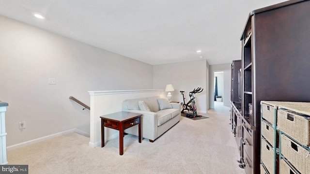 sitting room with light colored carpet, baseboards, an upstairs landing, and recessed lighting