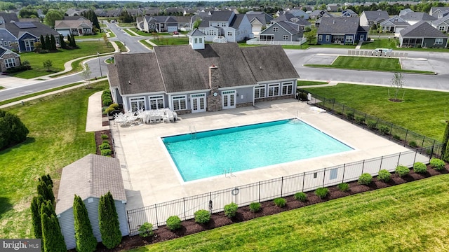 pool with fence, french doors, and a residential view