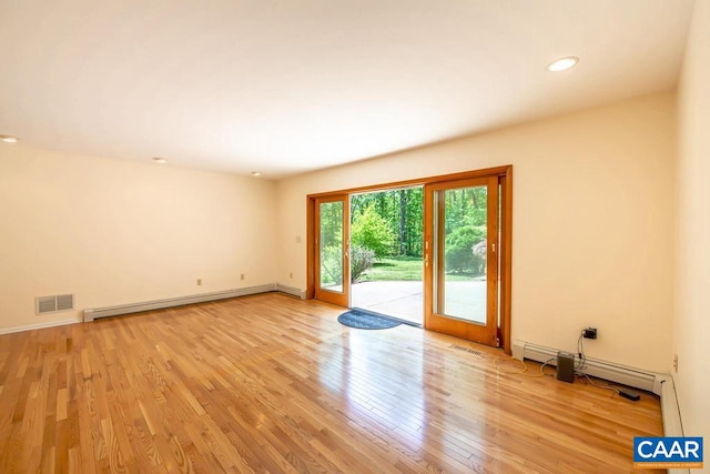 spare room featuring recessed lighting, a baseboard heating unit, baseboards, visible vents, and light wood-style floors