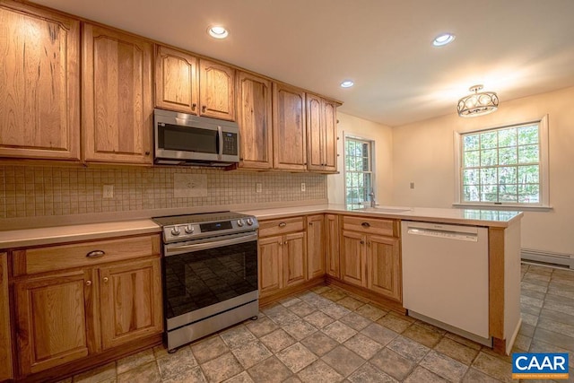 kitchen featuring light countertops, stainless steel appliances, tasteful backsplash, and plenty of natural light