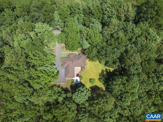 birds eye view of property with a wooded view
