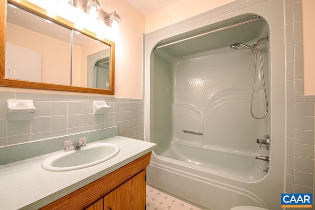 full bathroom featuring tile walls, vanity, and shower / bathing tub combination