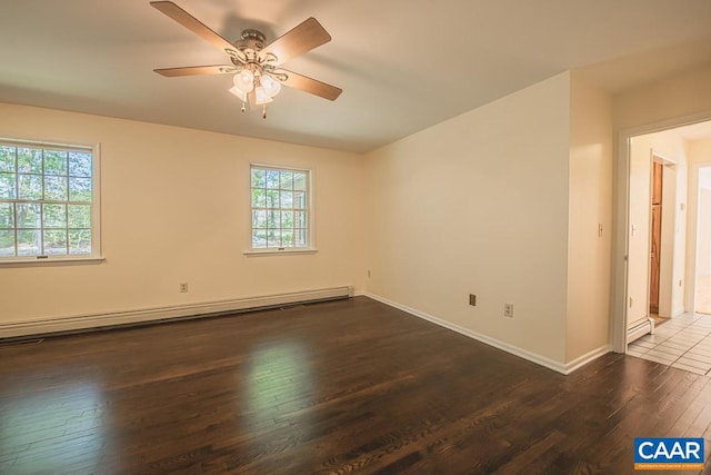 empty room featuring ceiling fan, baseboards, a baseboard heating unit, and hardwood / wood-style flooring