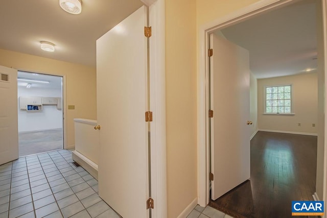 hallway featuring visible vents and baseboards