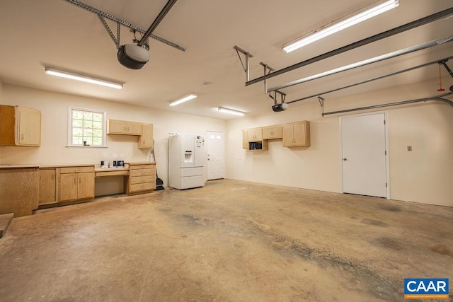 garage featuring white fridge with ice dispenser and a garage door opener