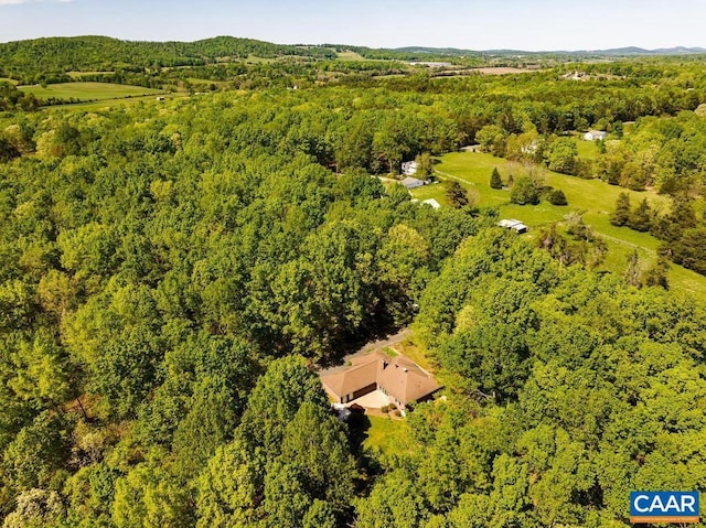 bird's eye view with a wooded view