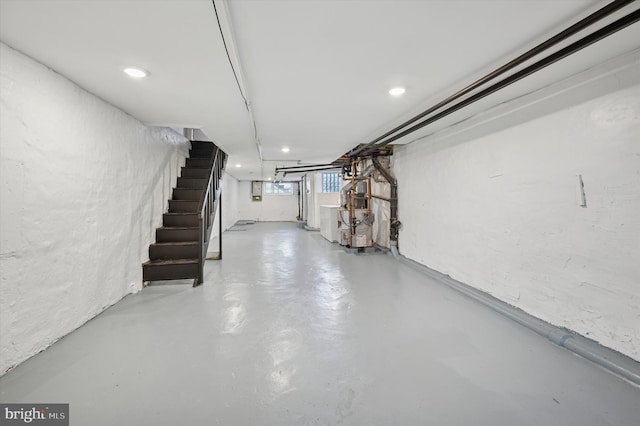 below grade area featuring stairway, heating unit, recessed lighting, and washer / clothes dryer