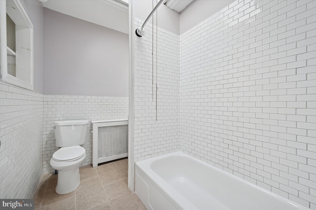 full bath with wainscoting, tile patterned flooring, toilet, radiator, and tile walls