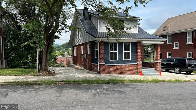 123 Cumberland St, Cumberland, MD 21502 - bungalow-style house featuring a chimney, a porch, metal roof, and brick siding