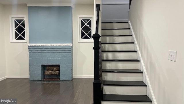 123 Cumberland St, Cumberland, MD 21502 - stairs featuring baseboards, wood finished floors, and a fireplace