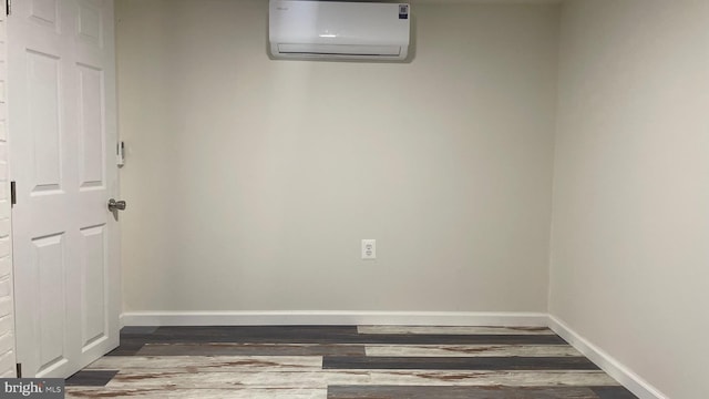 123 Cumberland St, Cumberland, MD 21502 - spare room with baseboards, wood finished floors, and a wall mounted air conditioner