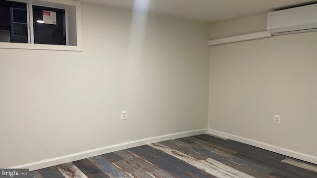 123 Cumberland St, Cumberland, MD 21502 - empty room featuring baseboards, dark wood-style flooring, and a wall mounted AC