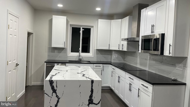123 Cumberland St, Cumberland, MD 21502 - kitchen with decorative backsplash, wall chimney exhaust hood, white cabinets, a sink, and appliances with stainless steel finishes