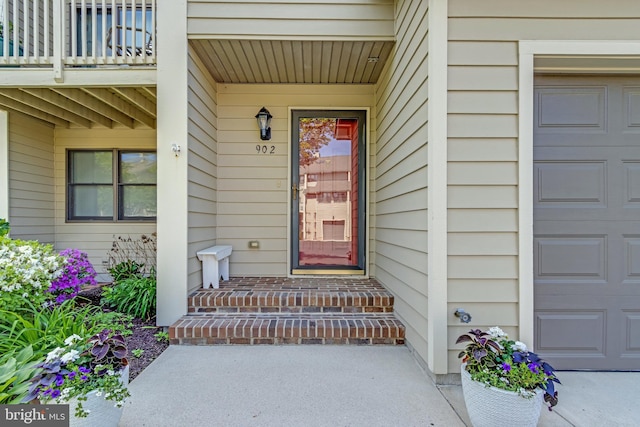 view of exterior entry featuring a balcony