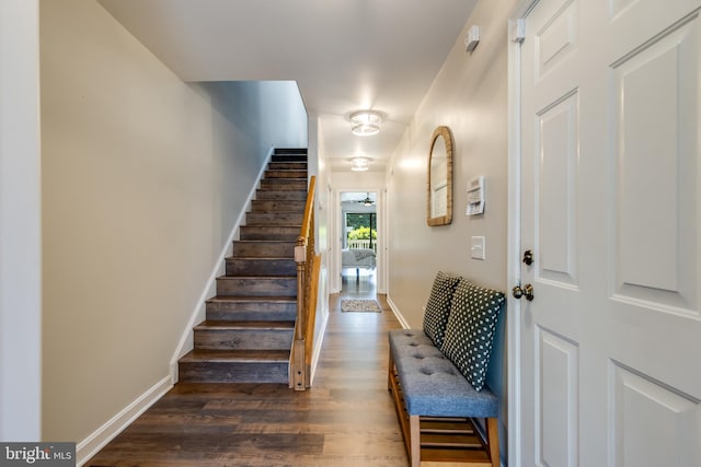 stairs with baseboards and wood finished floors