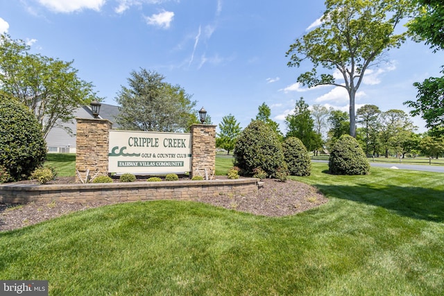 community sign featuring a lawn