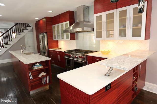 2129 E Lombard St, Baltimore, MD 21231 - kitchen featuring wall chimney exhaust hood, high end appliances, dark brown cabinets, baseboards, and recessed lighting