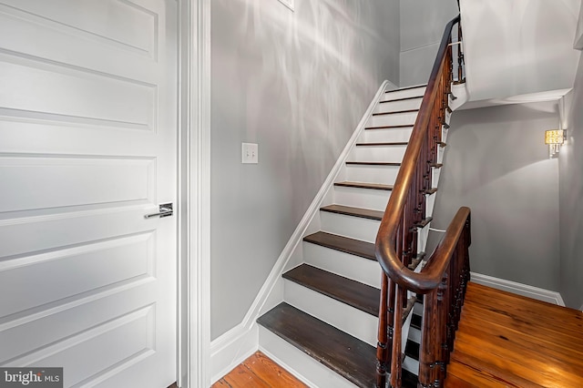 2129 E Lombard St, Baltimore, MD 21231 - stairs with baseboards and wood finished floors