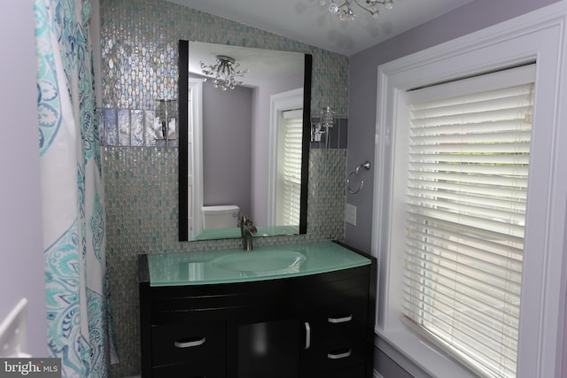 2129 E Lombard St, Baltimore, MD 21231 - full bathroom with a chandelier, vanity, and toilet