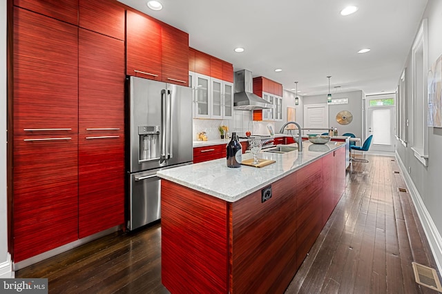 2129 E Lombard St, Baltimore, MD 21231 - kitchen featuring high end fridge, wall chimney exhaust hood, a center island with sink, modern cabinets, and dark wood finished floors