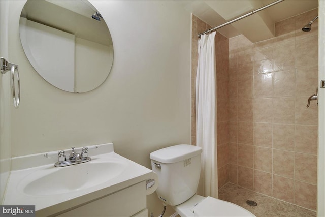 bathroom with vanity, a stall shower, and toilet