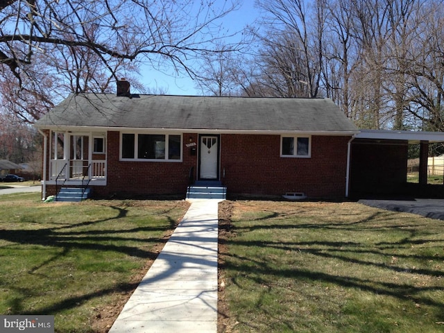 view of front of house with brick siding, a front yard, and a chimney