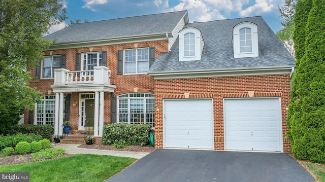 712 Pearson Point Pl, Annapolis, MD 21401 - colonial house with roof with shingles, asphalt driveway, brick siding, and a garage
