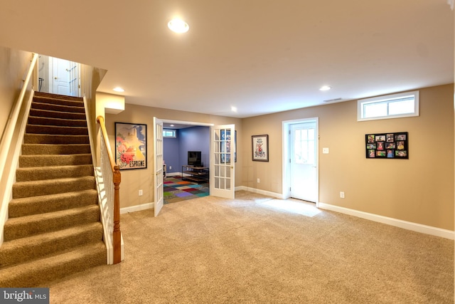 712 Pearson Point Pl, Annapolis, MD 21401 - below grade area with light colored carpet, baseboards, stairway, and recessed lighting