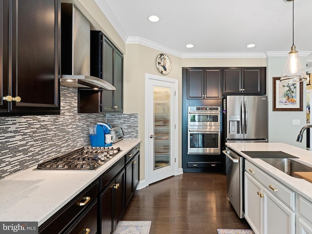 kitchen featuring decorative backsplash, light stone countertops, dark wood-style floors, stainless steel appliances, and wall chimney exhaust hood