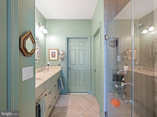 bathroom featuring a sink, tile patterned flooring, a shower stall, and double vanity