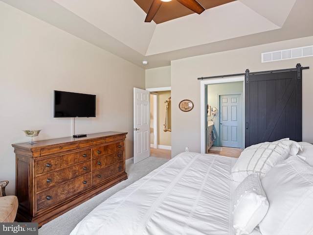 bedroom featuring visible vents, baseboards, light colored carpet, a barn door, and a ceiling fan