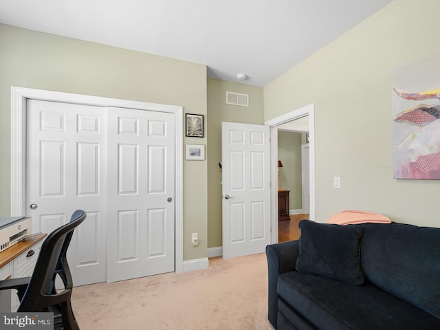 home office featuring visible vents, baseboards, and light colored carpet