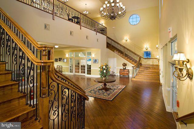 interior space with wood finished floors, stairs, and a high ceiling