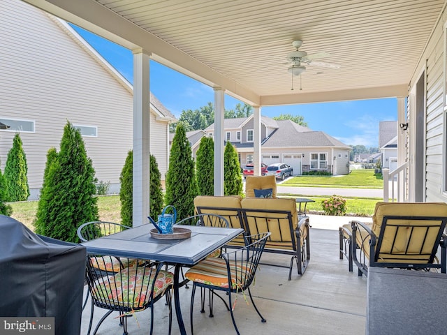 view of patio featuring outdoor dining area, a ceiling fan, and a residential view