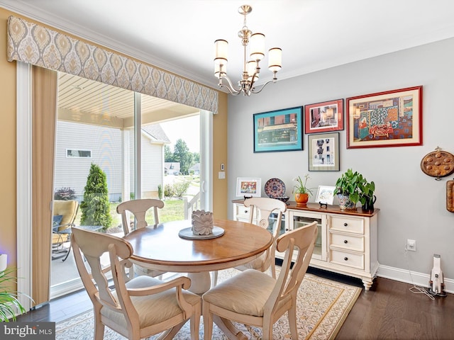 dining space featuring crown molding, baseboards, dark wood finished floors, and a chandelier