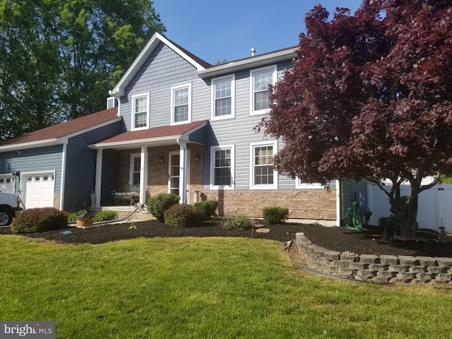 4 Honeysuckle Dr, Robbinsville, NJ 08691 - view of front facade with stone siding, an attached garage, covered porch, and a front yard