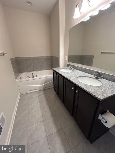 bathroom with a bath, visible vents, tile patterned flooring, and a sink